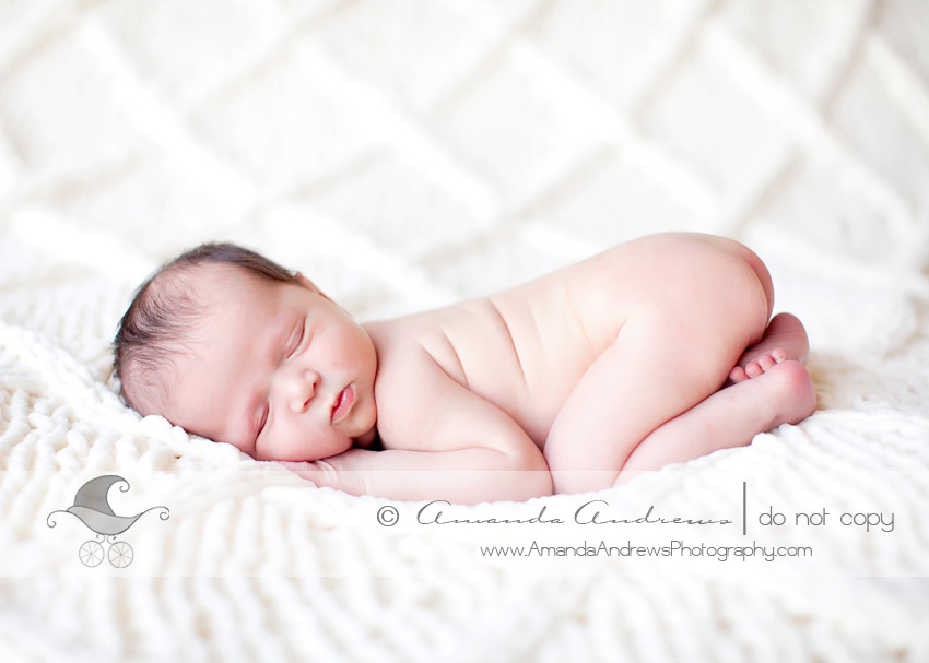  baby on white blanket with diamonds