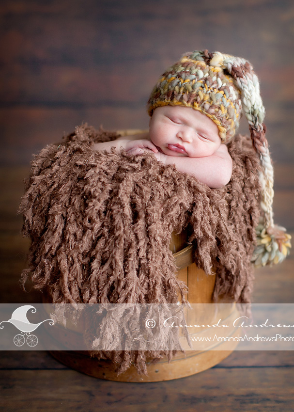 baby in wood firket bucket