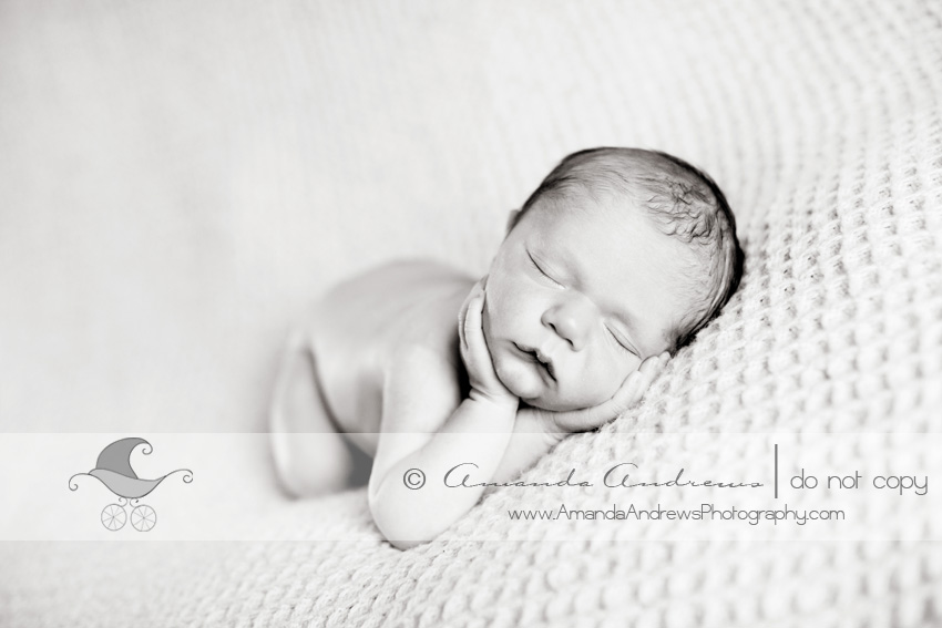  picture of baby sleeping on blanket with hands on chin