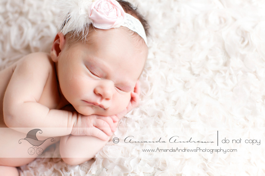 picture of baby girl on white flower blanket