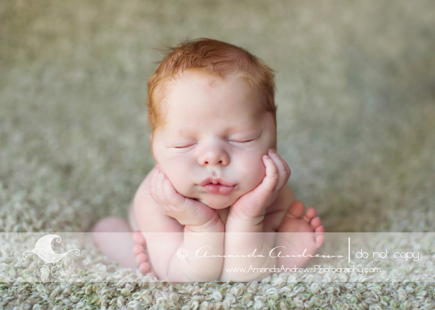 baby boy with chin in hands