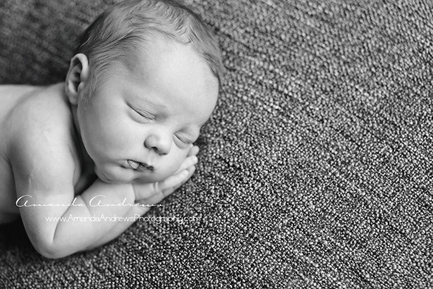 black and white photo of baby asleep on hands nampa idaho