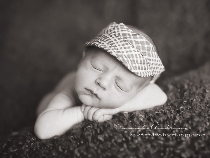 sleeping newborn with visor on meridian photographer