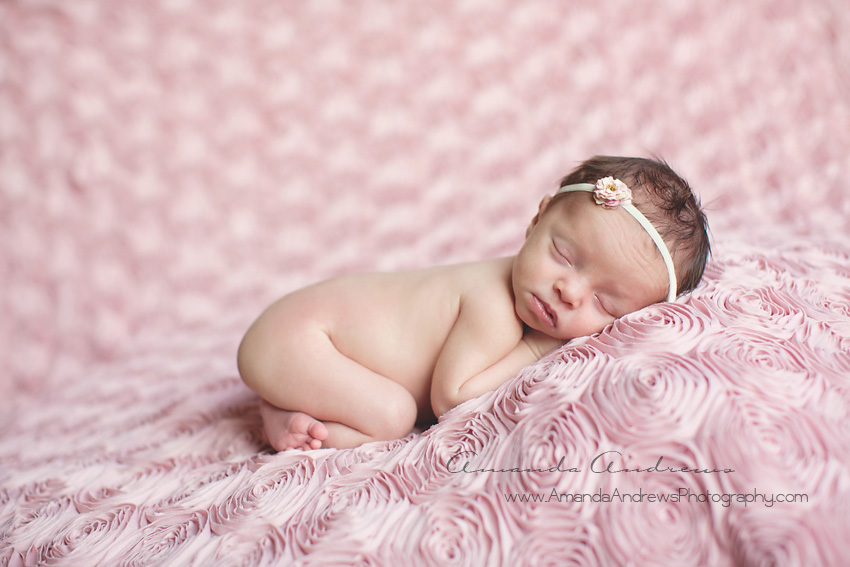 infant sleeping on rose blanket