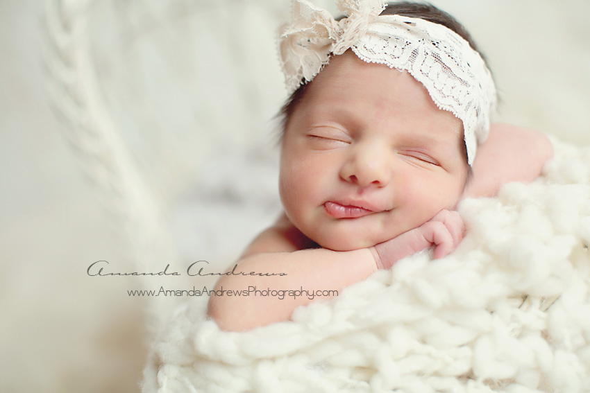 sleeping newborn with smile