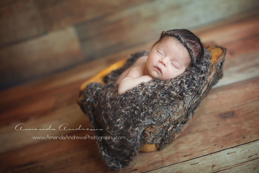 picture of baby girl sleeping in wooden bowl boise