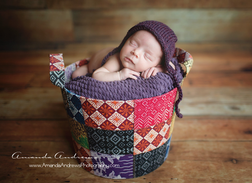 baby girl sleeping in colorful basket