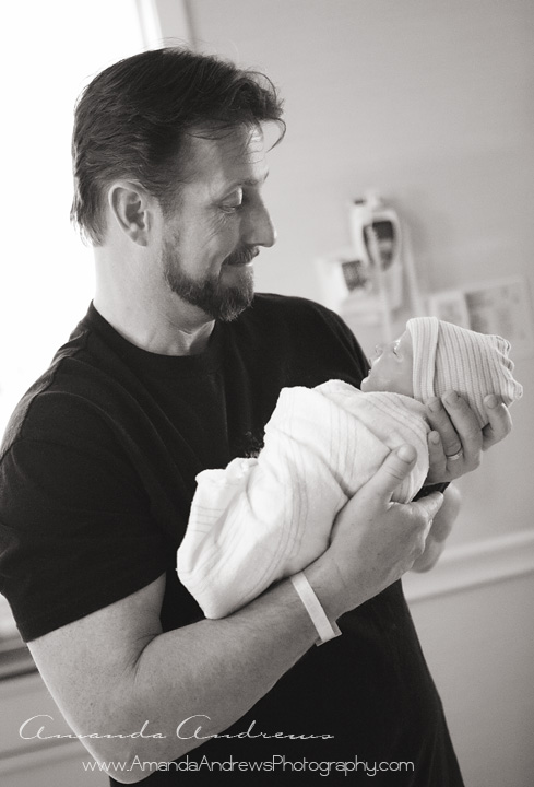 photo of dad holding brand new baby