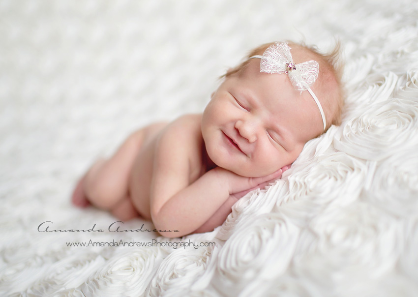 photo of infant sleeping with smile