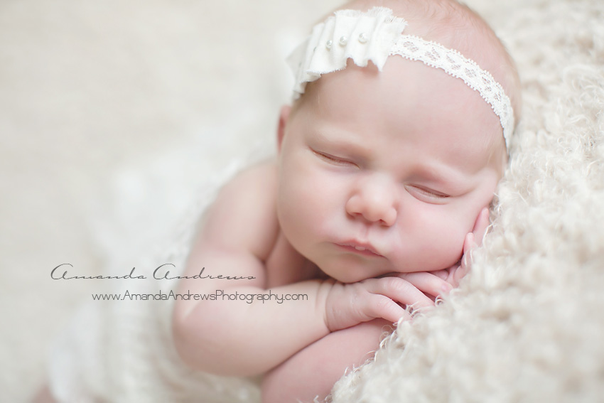 newborn asleep with hands under cheek