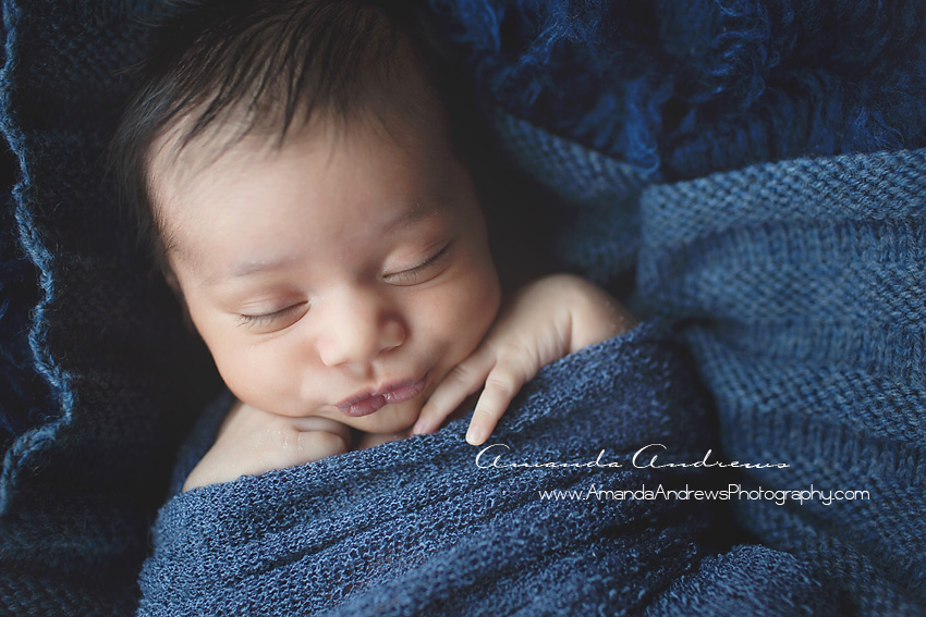close-up photo of sleeping baby wrapped in blue boise idaho