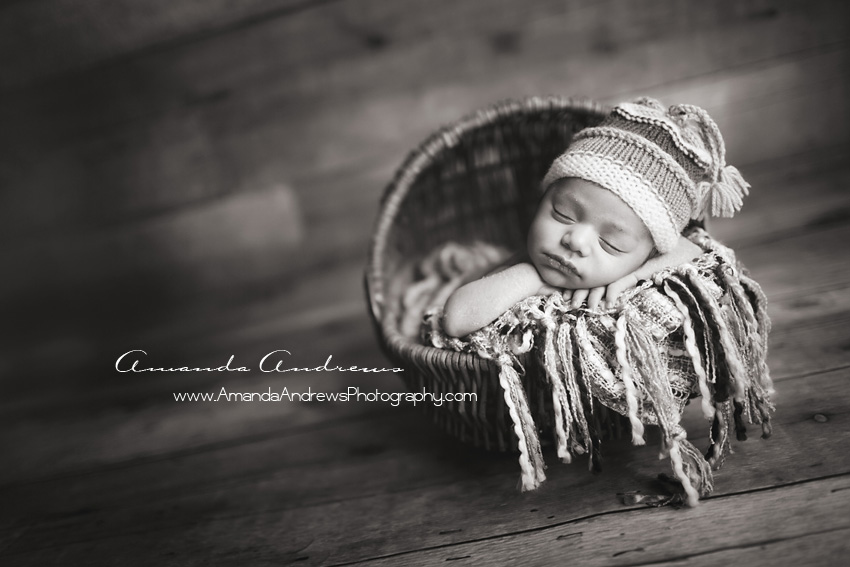 black and white picture of baby asleep in wicker basket boise idaho