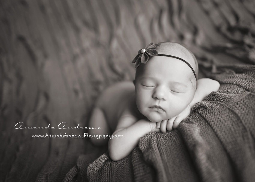 baby sleeping on gray ruffle blanket