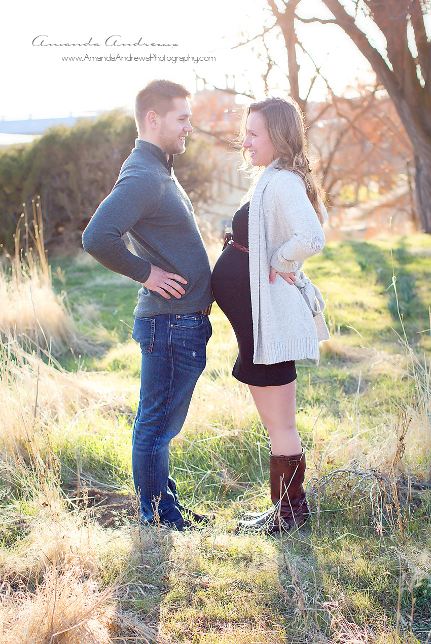 picture of pregnant woman bumping bellies with husband