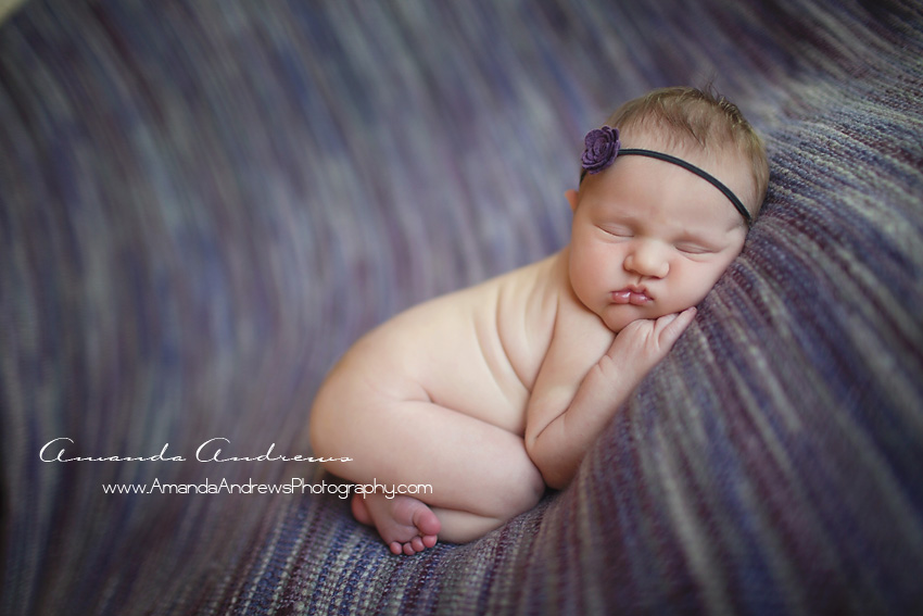 baby sleeping on purple blanket