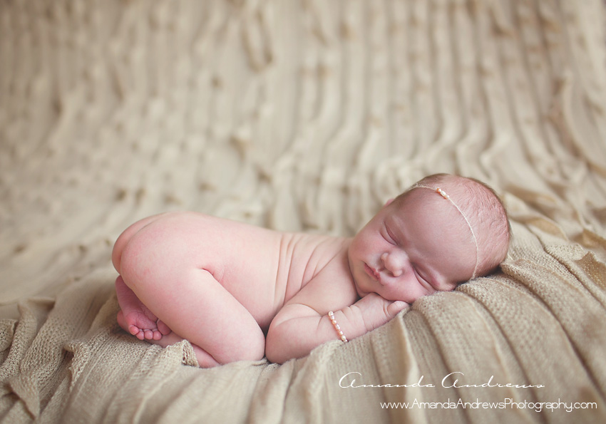 sleeping baby on tan blanket