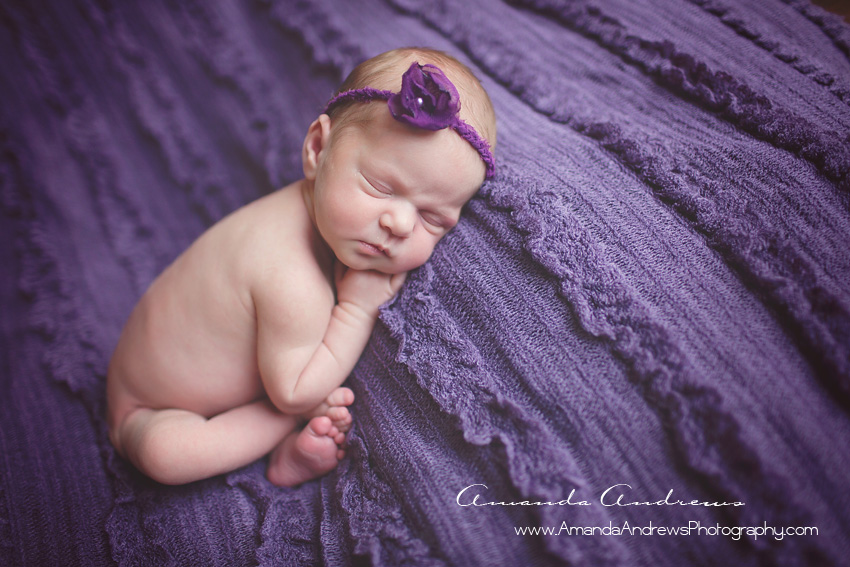 baby sleeping on purple blanket