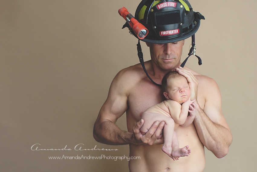 fireman holding sleeping newborn 