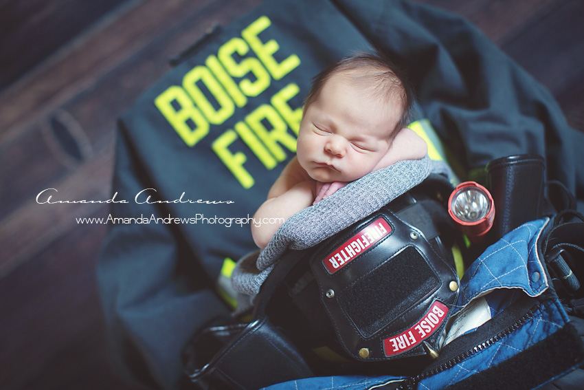 baby sleeping in fireman helmet