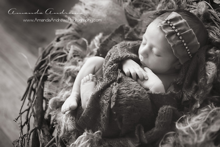 newborn sleeping in basket