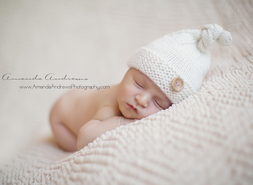 newborn sleeping with white hat