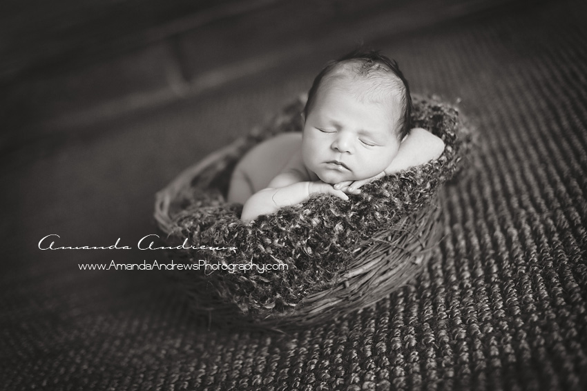 newborn sleeping in wicker basket