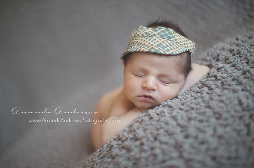 sleeping newborn with cap on